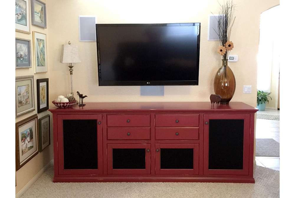 A media center with speaker fabric grill inserts in the doors